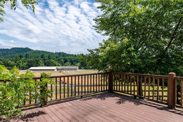 wooden deck with a wooded view