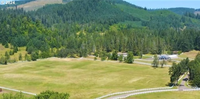 exterior space featuring a rural view and a view of trees