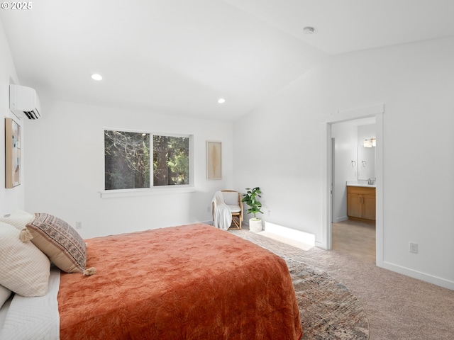 carpeted bedroom with lofted ceiling, sink, a wall mounted AC, and ensuite bathroom