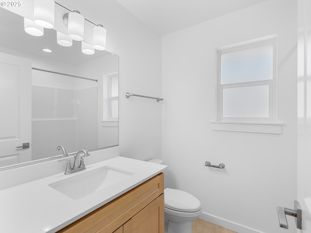 bathroom featuring walk in shower, vanity, and toilet