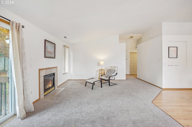 unfurnished room featuring a fireplace and light colored carpet