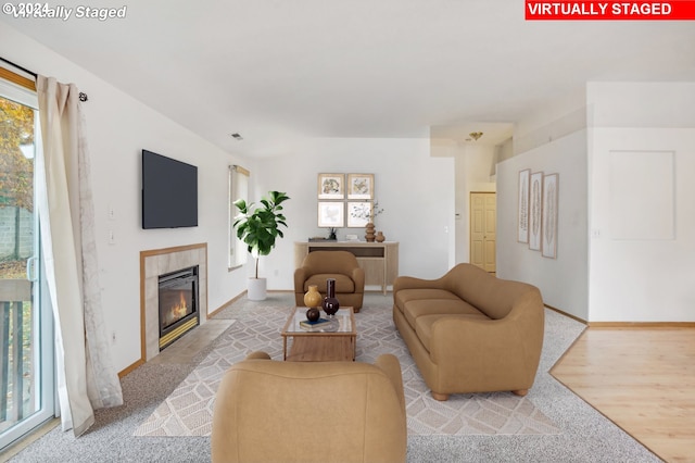 living room with a fireplace and light carpet