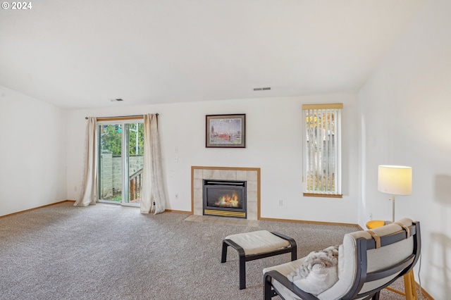 sitting room featuring a fireplace and carpet floors