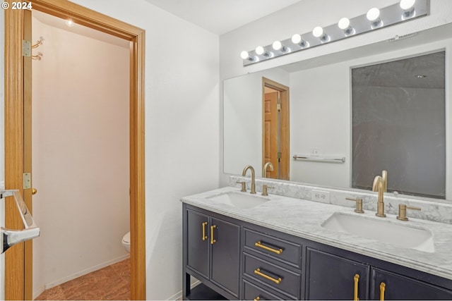 bathroom featuring toilet, vanity, and tile patterned floors