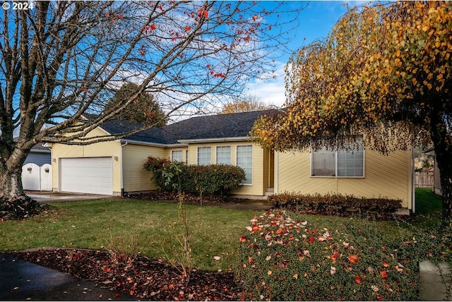 view of front of house with a garage and a front lawn