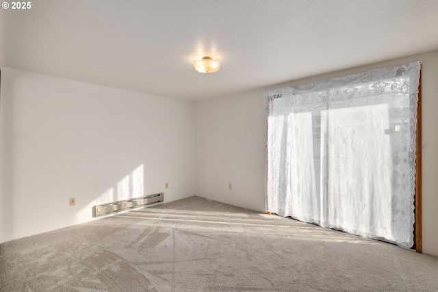 carpeted empty room with baseboard heating