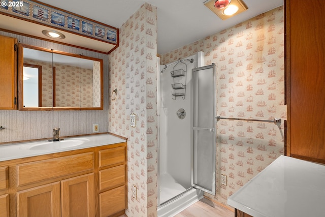 bathroom with vanity and a shower with shower door