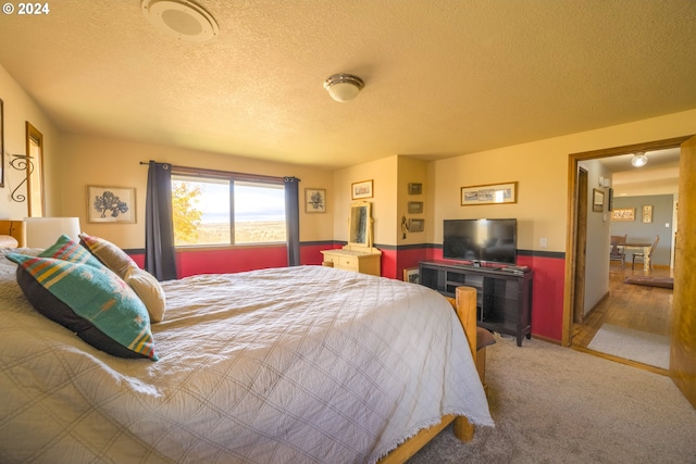 carpeted bedroom featuring a textured ceiling