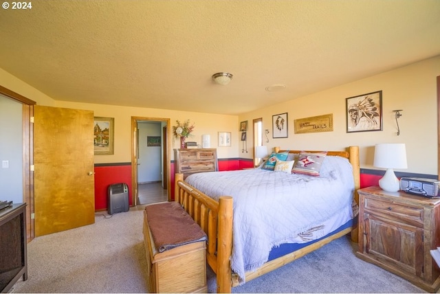 carpeted bedroom with a textured ceiling