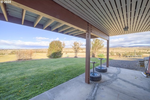 view of yard featuring a patio and a rural view