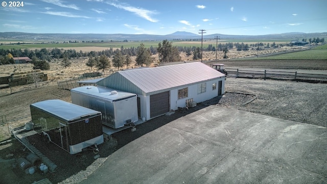 drone / aerial view with a mountain view and a rural view