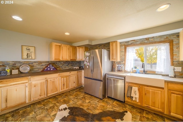 kitchen with backsplash, stainless steel appliances, and sink