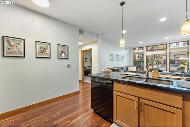 kitchen featuring dark stone counters, dark hardwood / wood-style flooring, pendant lighting, sink, and black dishwasher