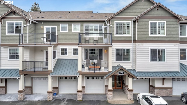 view of property featuring a balcony and a garage