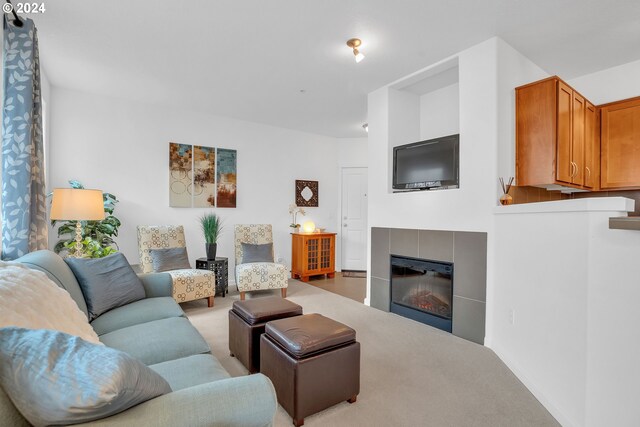 carpeted living room featuring a tile fireplace