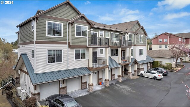 view of front facade with a garage and a balcony