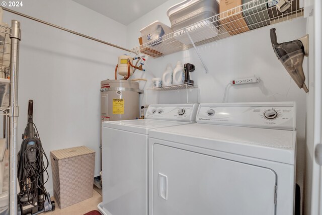 laundry room with washer and clothes dryer and water heater