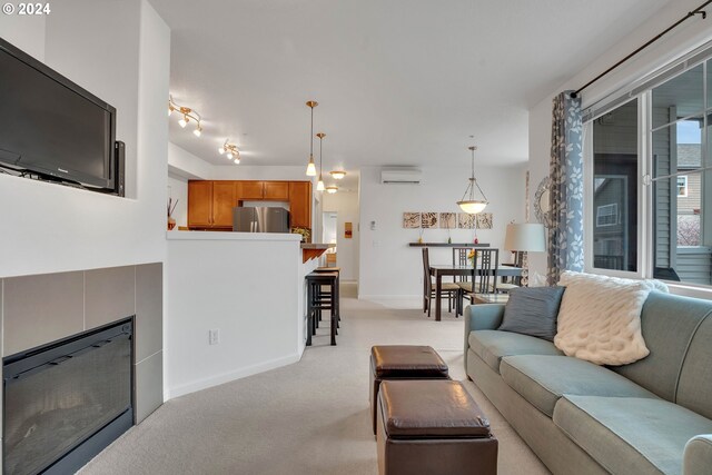 living room featuring a wall mounted air conditioner and light colored carpet