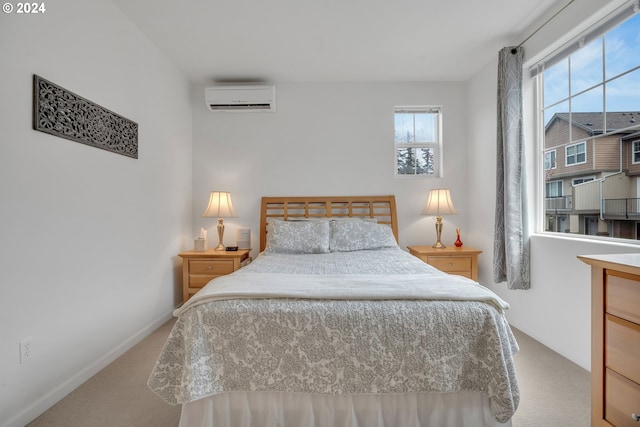 bedroom with baseboards, an AC wall unit, and carpet flooring