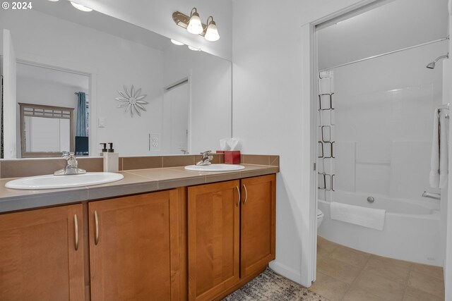 full bathroom featuring vanity, toilet, tile patterned floors, and washtub / shower combination