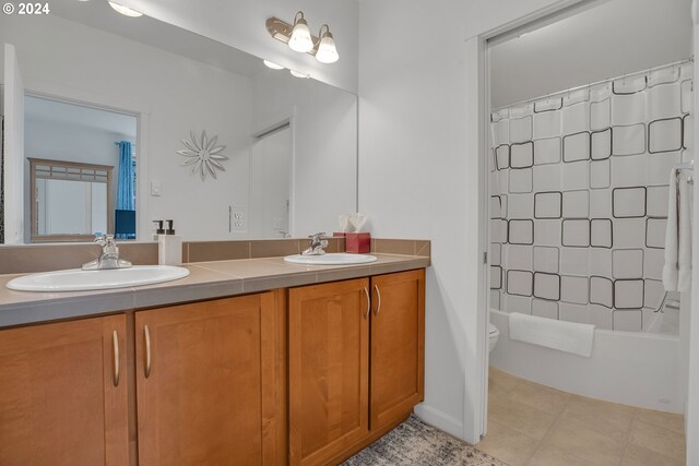 full bathroom featuring vanity, toilet, shower / bath combination with curtain, and tile patterned flooring