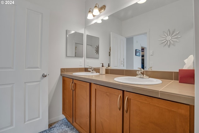 bathroom with double vanity and a sink