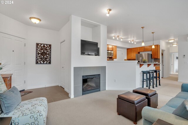 carpeted living room featuring a fireplace