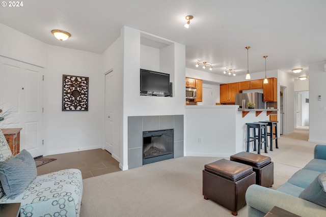 living area featuring baseboards and light carpet