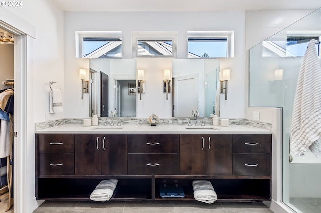 bathroom featuring vanity and a shower with door