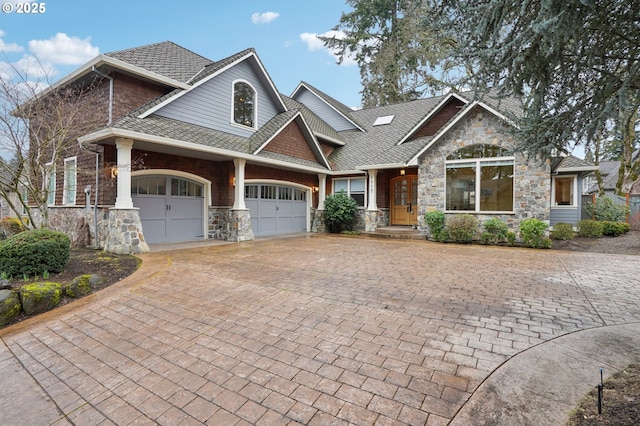 craftsman-style home featuring a shingled roof and decorative driveway