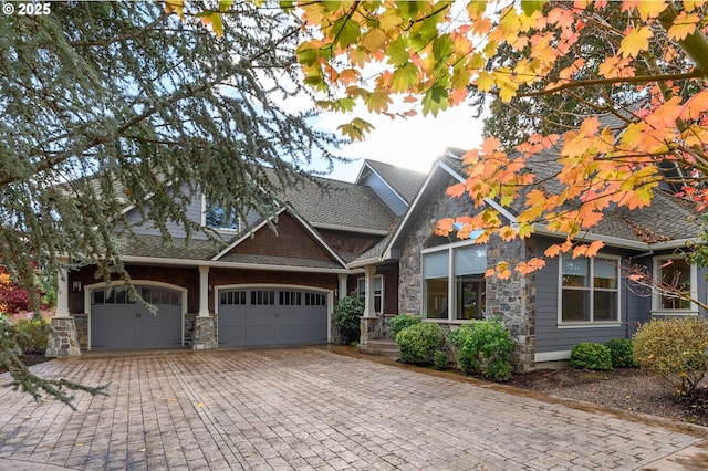 1113 SW Courtney Laine Dr, Mcminnville, OR 97128 - craftsman house featuring an attached garage, decorative driveway, and stone siding