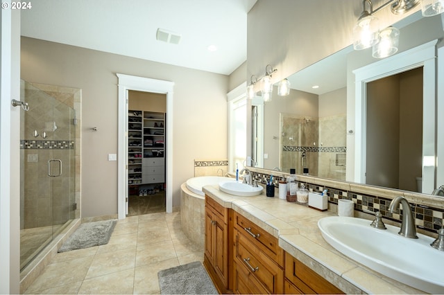 bathroom featuring vanity, walk in shower, and tile patterned flooring