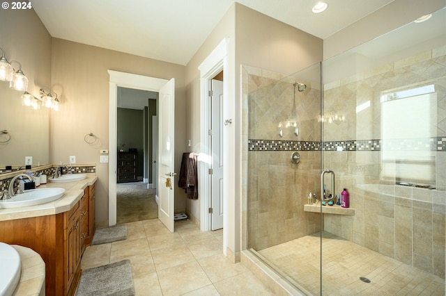 bathroom with vanity, walk in shower, and tile patterned floors