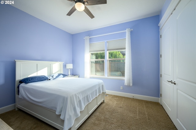 carpeted bedroom with a closet and ceiling fan