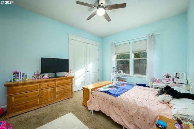 carpeted bedroom featuring a closet and ceiling fan