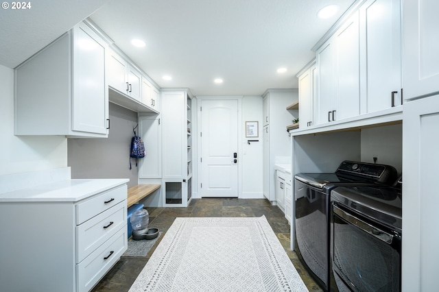 washroom featuring cabinets and separate washer and dryer