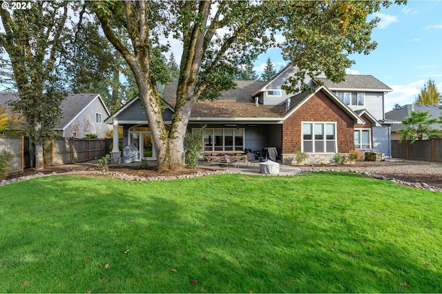 rear view of property with a patio area and a lawn