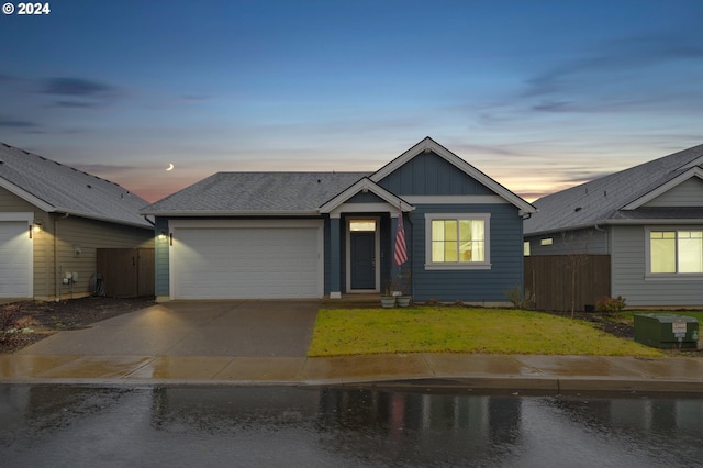 view of front of house featuring a garage and a lawn