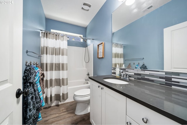 full bathroom featuring shower / tub combo with curtain, vanity, wood-type flooring, and toilet