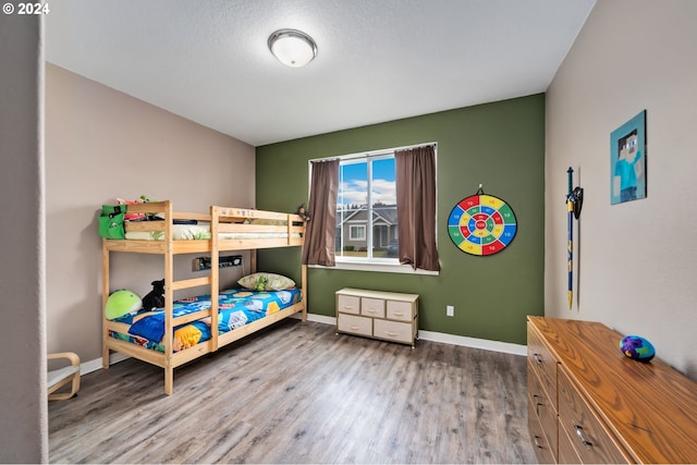 bedroom featuring light wood-type flooring and a textured ceiling