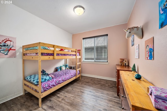 bedroom with dark wood-type flooring