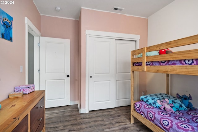 bedroom featuring dark wood-type flooring and a closet