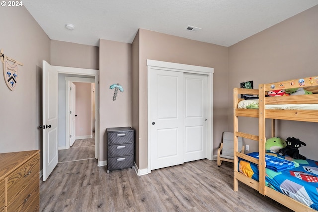 bedroom featuring light hardwood / wood-style floors and a closet