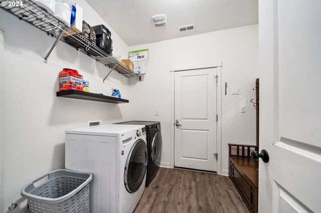 laundry room with independent washer and dryer, dark hardwood / wood-style flooring, and a textured ceiling