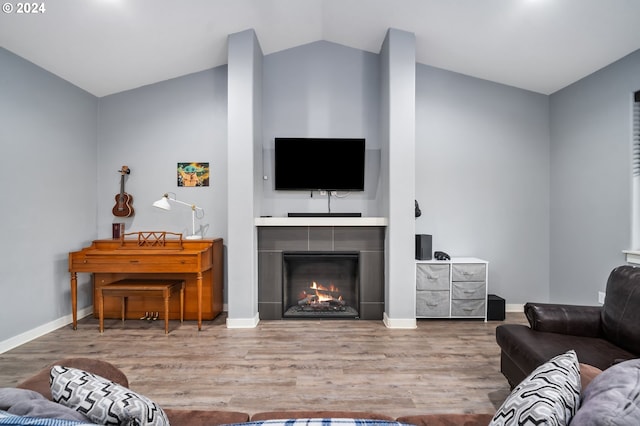 living room with hardwood / wood-style flooring and lofted ceiling