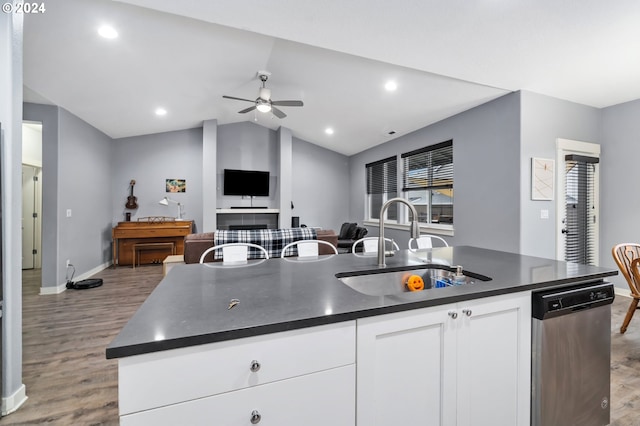 kitchen with sink, a center island with sink, light wood-type flooring, dishwasher, and white cabinets