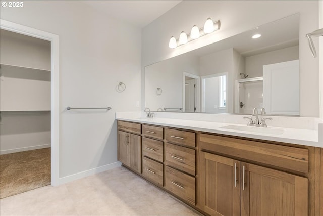 bathroom featuring vanity and an enclosed shower