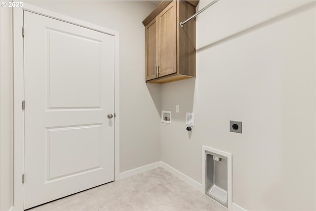 laundry area with cabinets, hookup for an electric dryer, and hookup for a washing machine