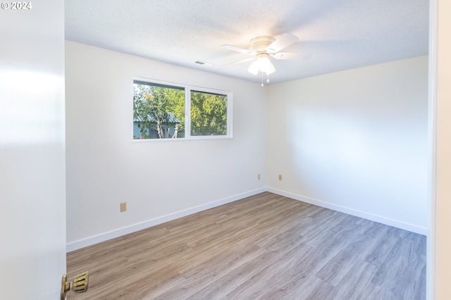 unfurnished room with ceiling fan, light hardwood / wood-style floors, and a textured ceiling