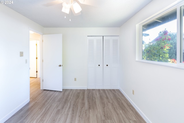 unfurnished bedroom featuring a closet, ceiling fan, and light hardwood / wood-style flooring